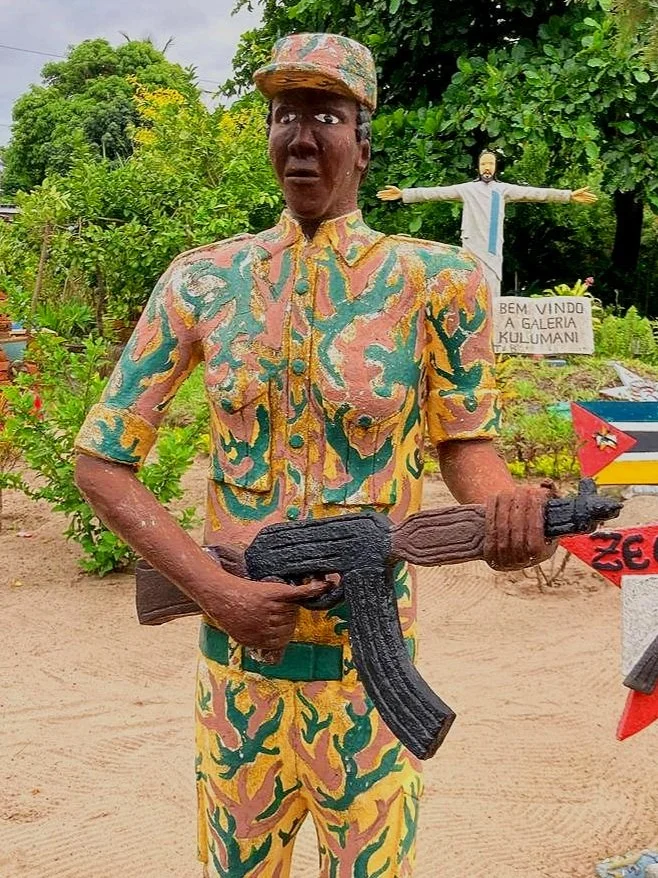Painted cement soldier sculpture in patterned uniform